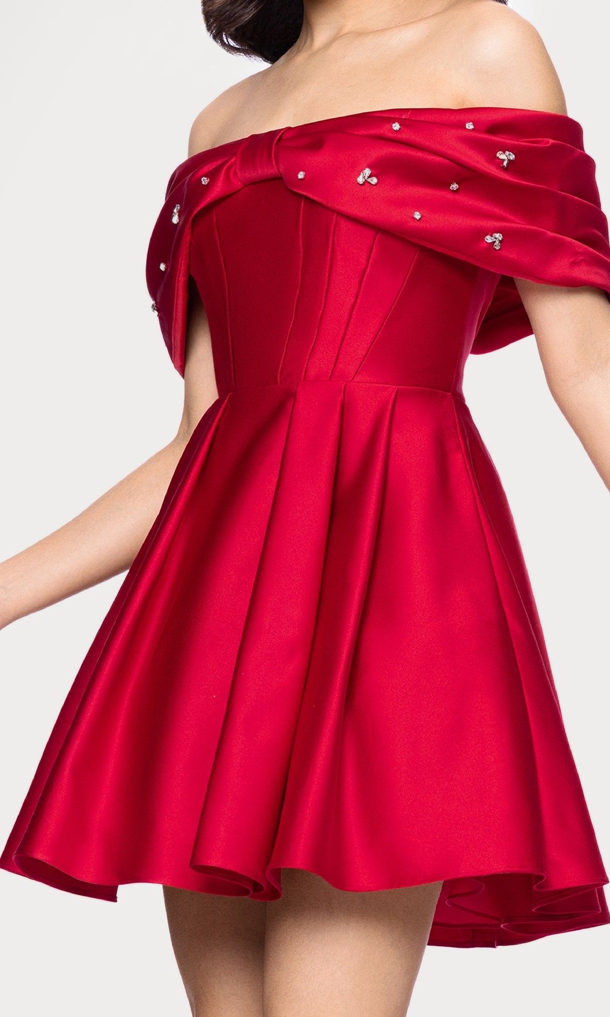 Wearing the Off-Shoulder Red Hoco Dress: Blondie Nites 5695BN, featuring a flared skirt, corset-style bodice, and embellished neckline.